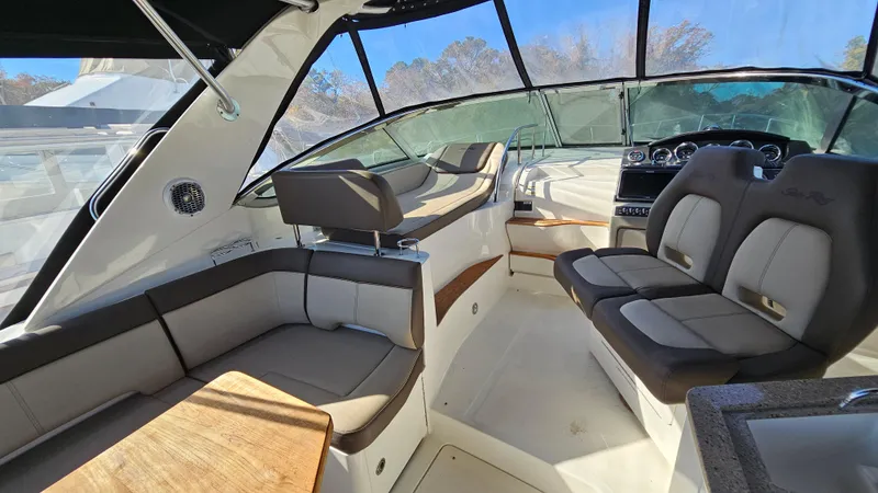 Slide: The Image of Interior of 2014 Sea Ray 350 Sundancer boat with luxurious seating and helm. - 12