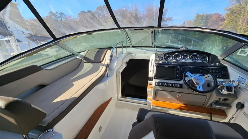 Slide: The Image of Interior of 2014 Sea Ray 350 Sundancer boat with modern helm and seating. - 15
