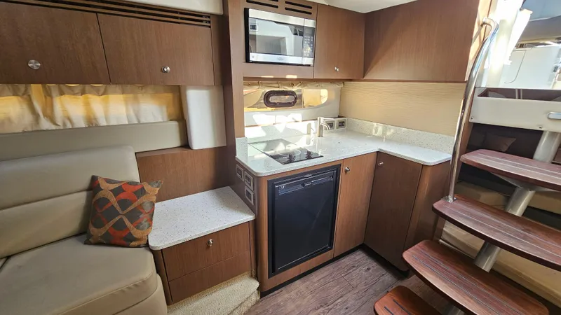 Slide: The Image of Interior of 2014 Sea Ray 350 Sundancer yacht with modern kitchen and seating area. - 21