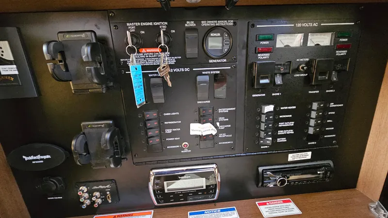 Slide: The Image of Control panel of a 2014 Sea Ray 350 Sundancer boat with switches and keys. - 25
