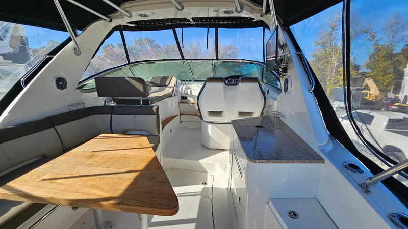 Slide: The Image of Interior of 2014 Sea Ray 350 Sundancer boat with seating and wooden table. - 3