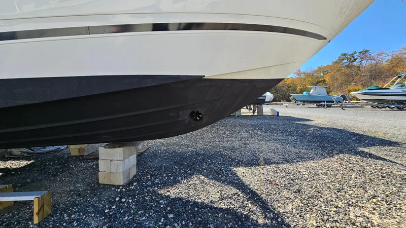 Slide: The Image of 2014 Sea Ray 350 Sundancer boat on blocks, gravel lot, sunny day. - 30