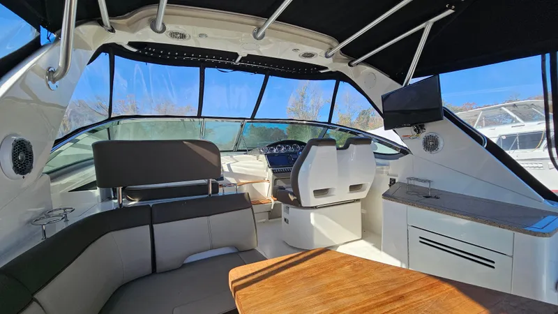 Slide: The Image of Interior of 2014 Sea Ray 350 Sundancer yacht with seating and helm. - 6