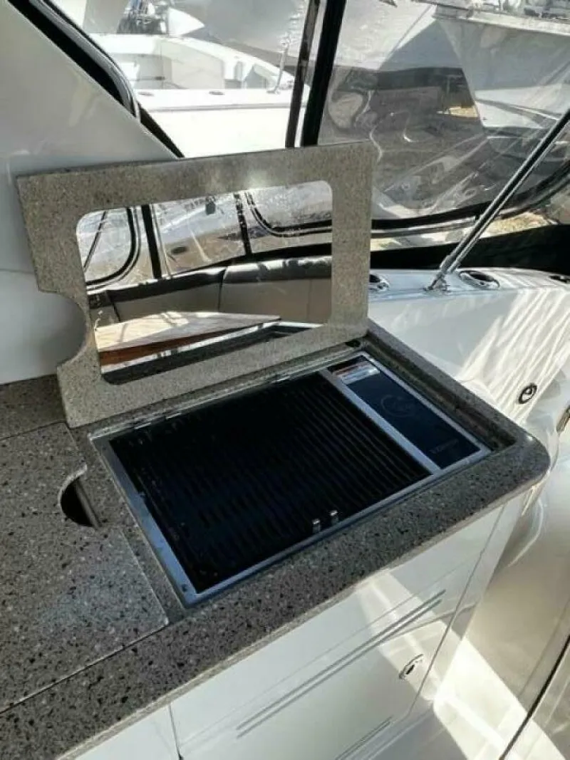 Slide: The Image of 2014 Sea Ray 350 Sundancer boat with built-in outdoor grill on deck. - 8