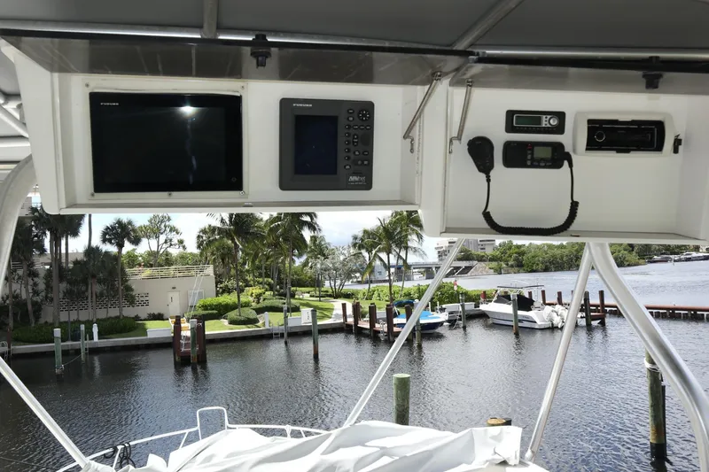 Slide: The Image of 2005 Luhrs 38 Convertible yacht cockpit with navigation equipment and waterfront view. - 10