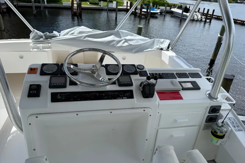 Slide: The Image of 2005 Luhrs 38 Convertible boat helm with steering wheel and control panel. - 13