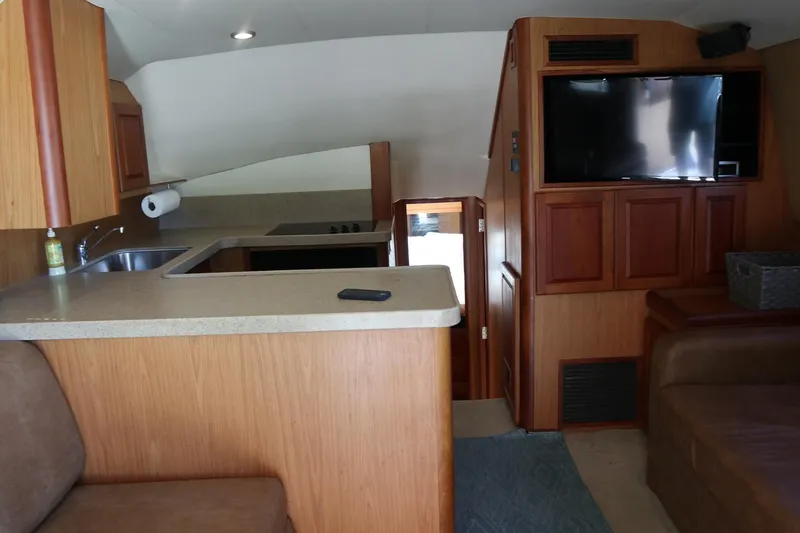 Slide: The Image of Interior of 2005 Luhrs 38 Convertible yacht with kitchen and seating area. - 21