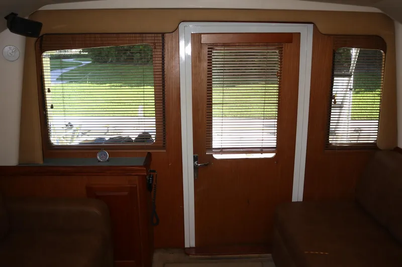 Slide: The Image of Interior view of 2005 Luhrs 38 Convertible yacht with wooden door and windows. - 26