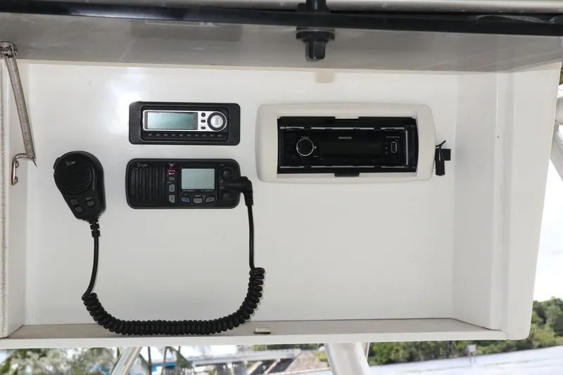 Slide: The Image of 2005 Luhrs 38 Convertible boat dashboard with radio and communication equipment. - 29