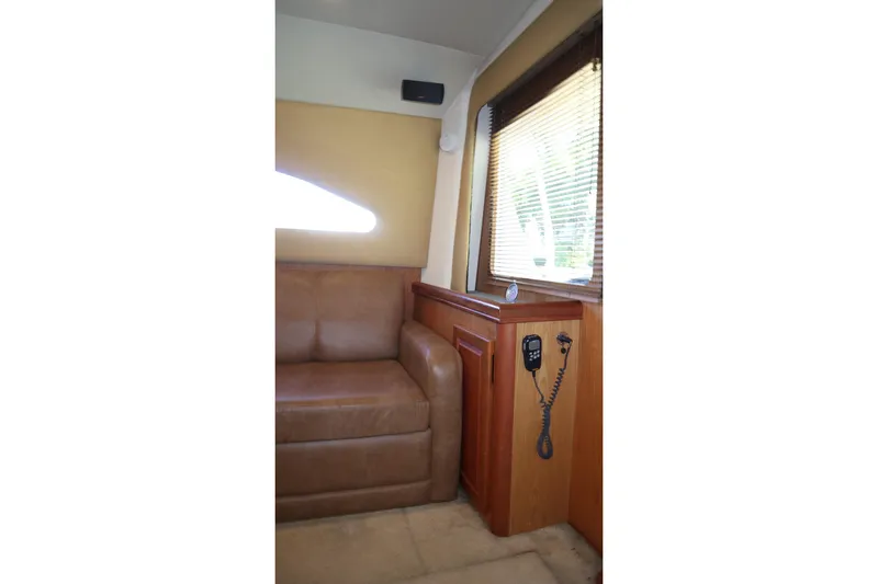 Slide: The Image of Interior of 2005 Luhrs 38 Convertible yacht with leather seating and wood paneling. - 32