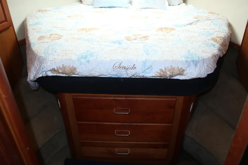 Slide: The Image of 2005 Luhrs 38 Convertible cabin with cozy bed and wooden storage drawers. - 39