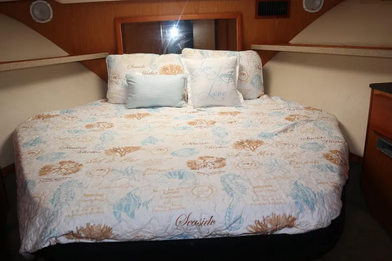 Slide: The Image of Cozy bedroom in 2005 Luhrs 38 Convertible yacht with nautical-themed bedding. - 40