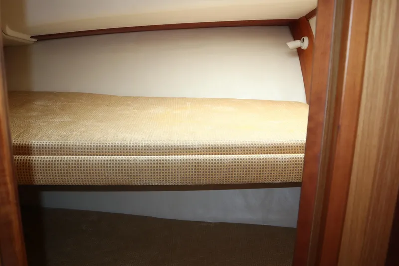 Slide: The Image of 2005 Luhrs 38 Convertible cabin interior with a cozy bunk bed. - 42