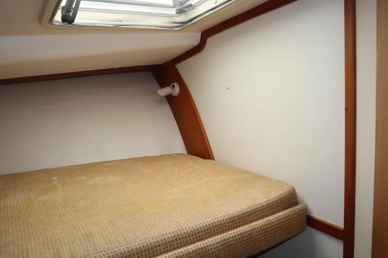 Slide: The Image of 2005 Luhrs 38 Convertible cabin interior with bed and porthole. - 43