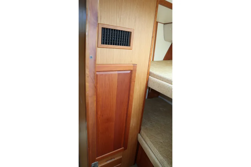 Slide: The Image of Interior view of 2005 Luhrs 38 Convertible boat with wooden paneling and bunk beds. - 44