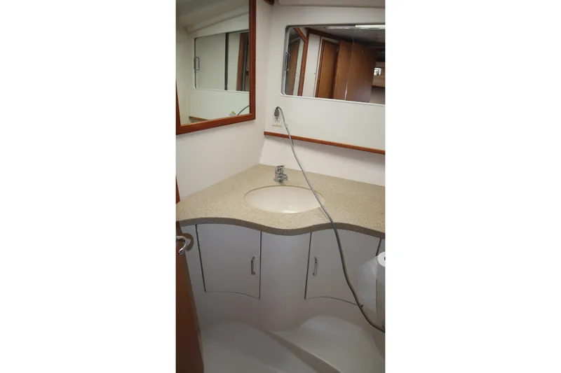 Slide: The Image of Bathroom interior of 2005 Luhrs 38 Convertible yacht with sink and mirror. - 50