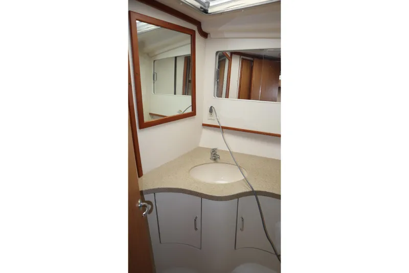 Slide: The Image of 2005 Luhrs 38 Convertible yacht bathroom with sink and mirror. - 51