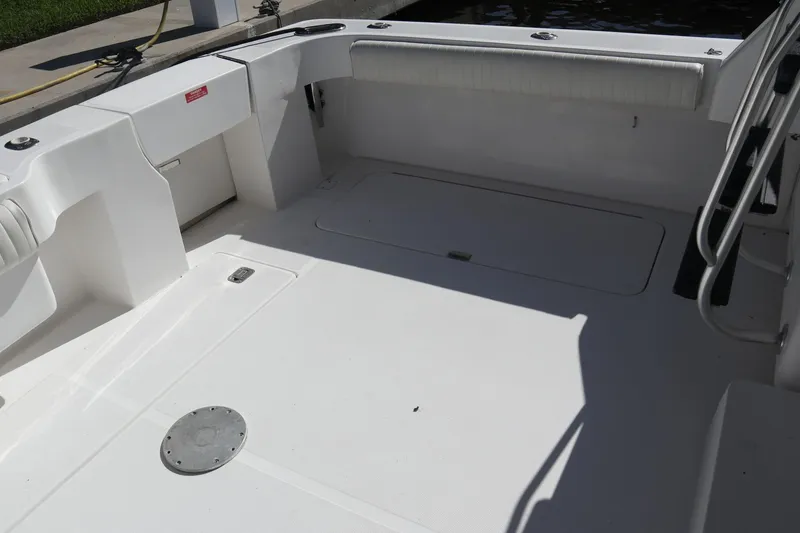 Slide: The Image of 2005 Luhrs 38 Convertible boat deck with clean, spacious layout and storage compartments. - 52