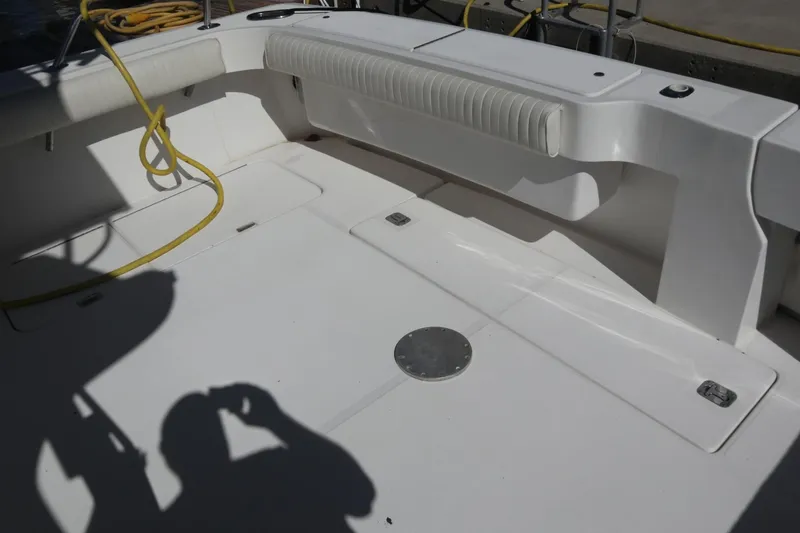Slide: The Image of 2005 Luhrs 38 Convertible boat deck with seating and coiled yellow rope. - 53