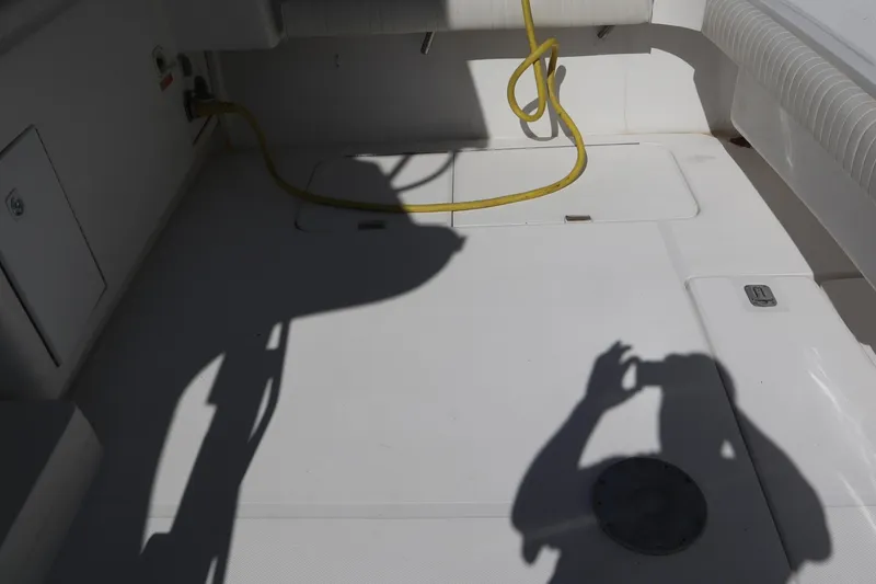 Slide: The Image of 2005 Luhrs 38 Convertible boat deck with shadow and yellow cable. - 55