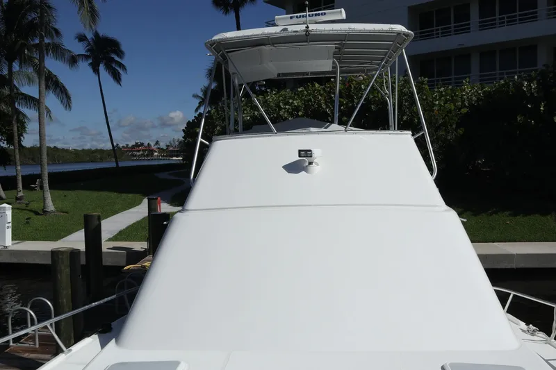 Slide: The Image of 2005 Luhrs 38 Convertible yacht docked near palm trees and waterfront. - 59