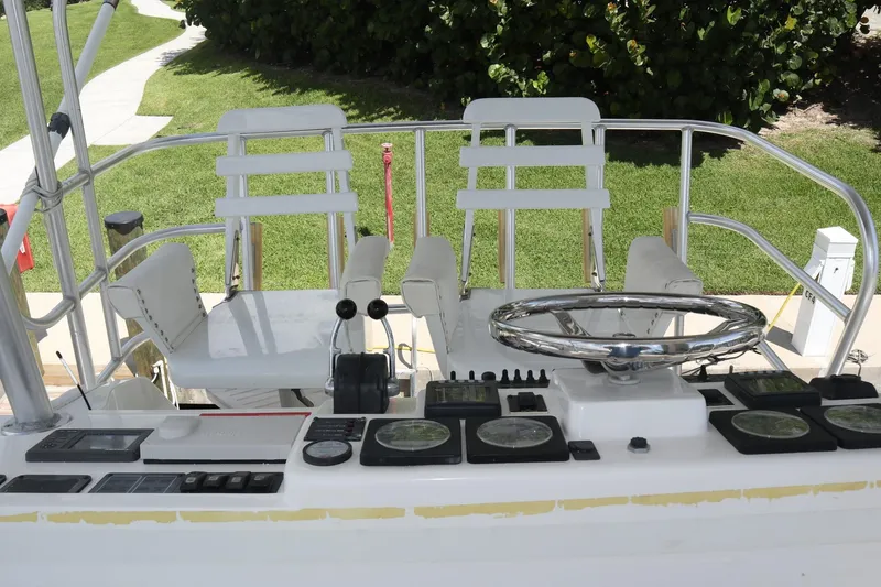 Slide: The Image of 2005 Luhrs 38 Convertible boat helm with dual seats and navigation controls. - 6