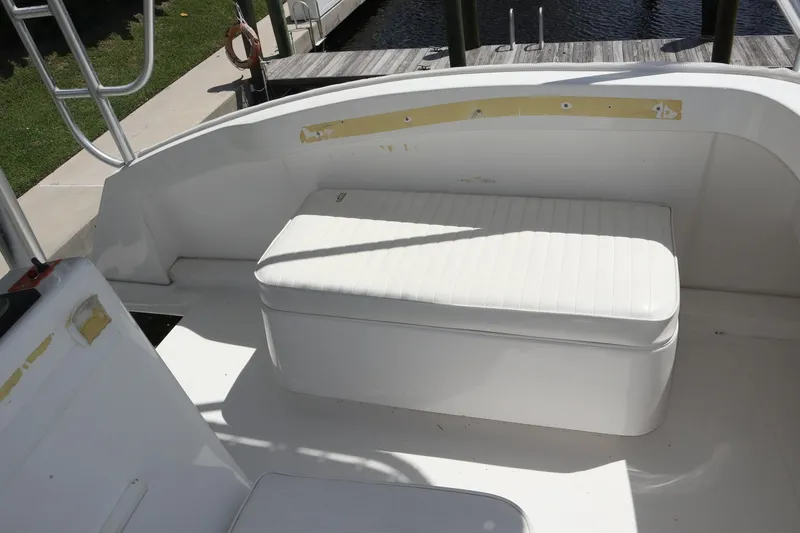 Slide: The Image of 2005 Luhrs 38 Convertible boat with white cushioned seating on deck. - 67