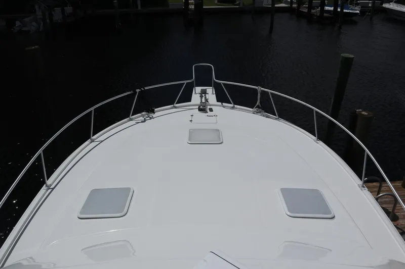 Slide: The Image of 2005 Luhrs 38 Convertible boat deck with railing, docked at marina. - 69