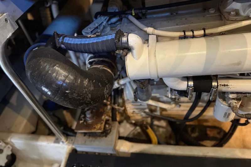 Slide: The Image of Engine compartment of a 2005 Luhrs 38 Convertible boat, showing hoses and mechanical components. - 71