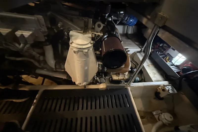 Slide: The Image of Engine room of a 2005 Luhrs 38 Convertible boat, showcasing mechanical components. - 74