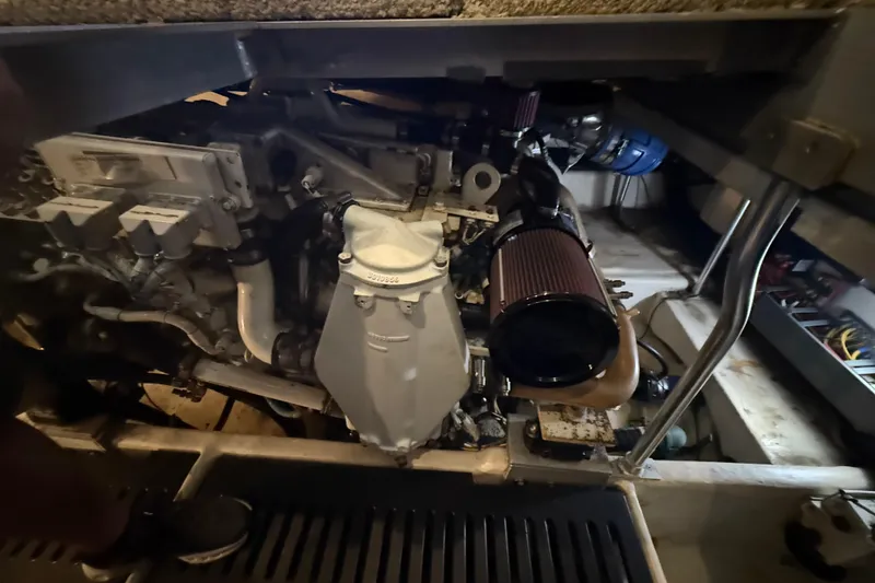 Slide: The Image of Engine compartment of a 2005 Luhrs 38 Convertible boat, showcasing mechanical components. - 75