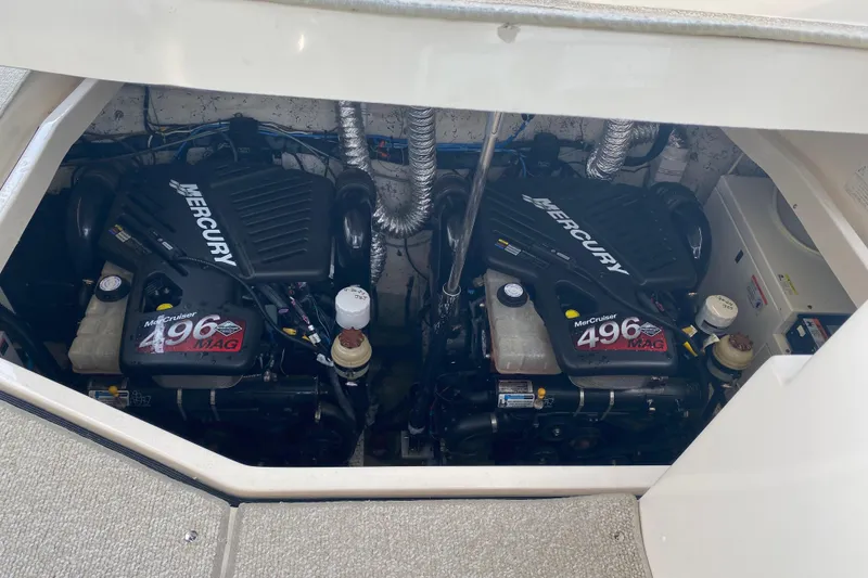 Slide: The Image of 2006 Rinker 360 Express Cruiser interior with beige seating and wooden table. - 14