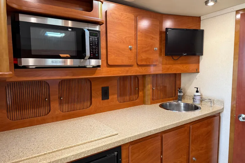 Slide: The Image of Shower area in 2006 Rinker 360 Express Cruiser boat, featuring a handheld showerhead. - 21