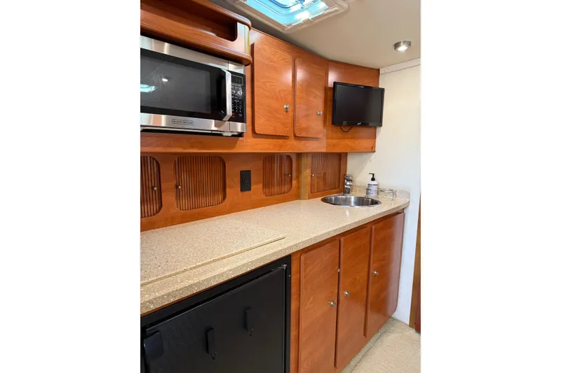 Slide: The Image of 2006 Rinker 360 Express Cruiser in storage, showcasing sleek design and white exterior. - 22