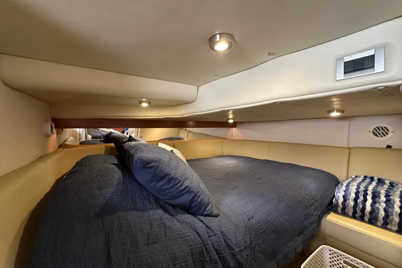 Slide: The Image of 2006 Rinker 360 Express Cruiser speeding on a calm lake under clear skies. - 24