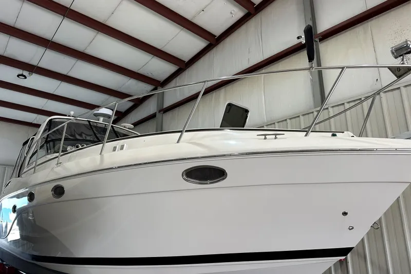 Slide: The Image of 2006 Rinker 360 Express Cruiser on calm water under a clear sky. - 28