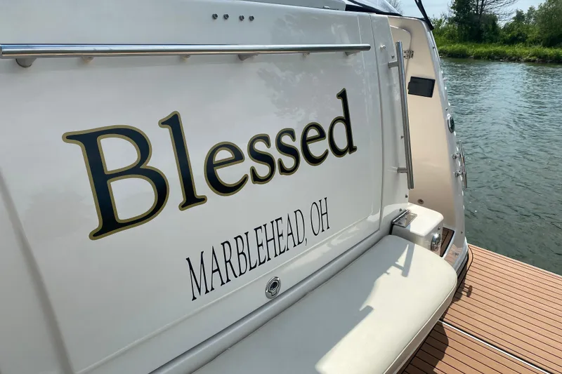 Slide: The Image of 2006 Rinker 360 Express Cruiser docked at a marina on a sunny day. - 8