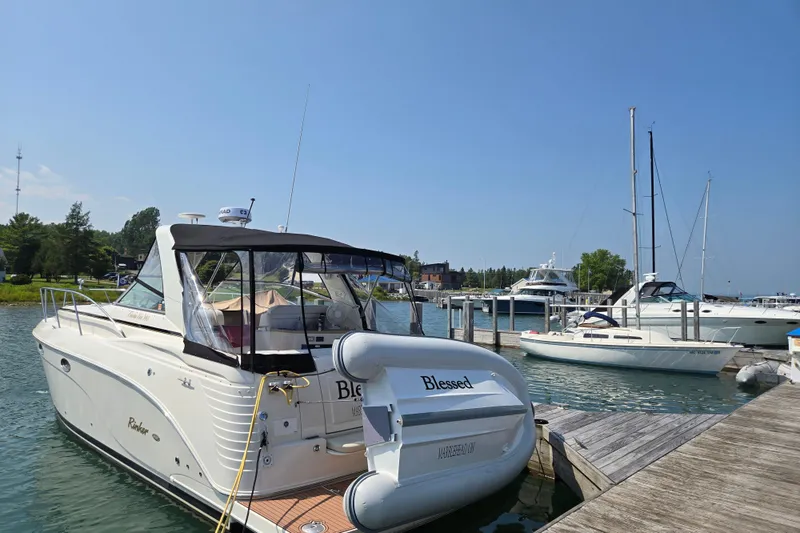 Slide: The Image of 2006 Rinker 360 Express Cruiser with blue LED lights at night. - 9