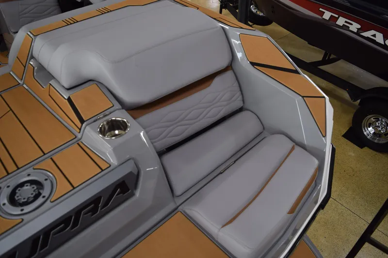 Slide: The Image of 2025 Supra SA boat interior with cushioned seating and wood accents. - 12