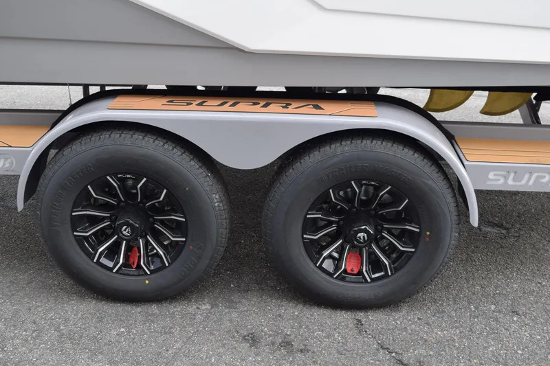 Slide: The Image of 2025 Supra SA trailer with dual black wheels and branded fender. - 18