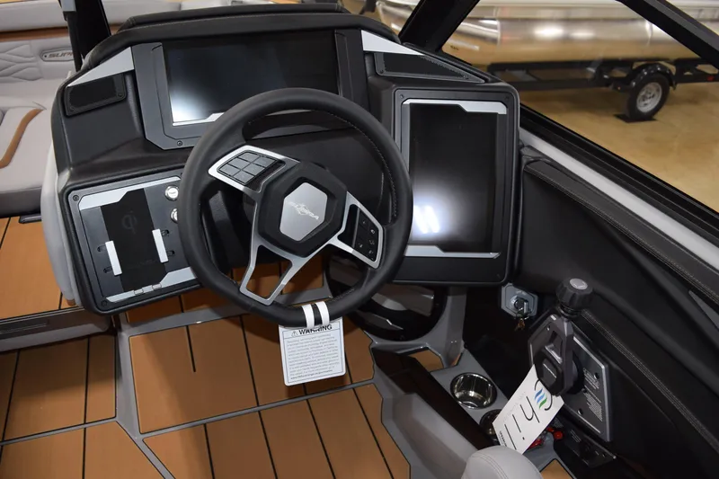 Slide: The Image of 2025 Supra SA boat dashboard with modern steering wheel and digital displays. - 7