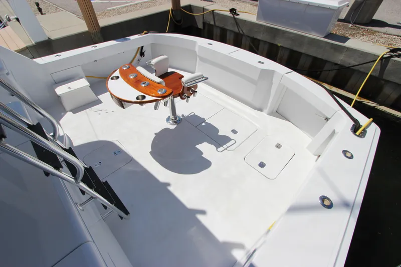 Slide: The Image of Spacious deck of 2004 Hatteras 60 Convertible yacht with fishing chair and rod holders. - 12