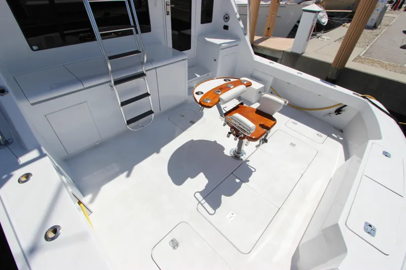Slide: The Image of 2004 Hatteras 60 Convertible yacht deck with fishing chair and ladder. - 13
