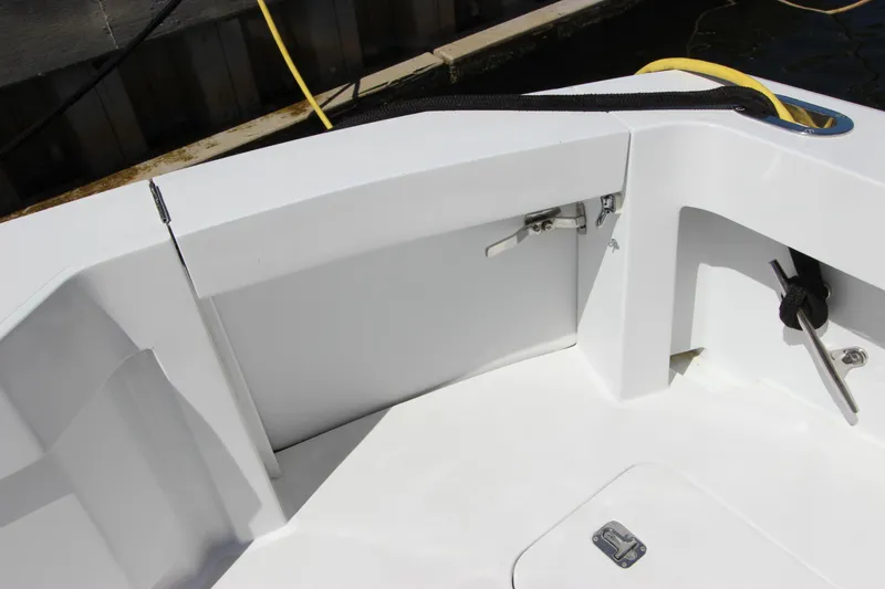 Slide: The Image of 2004 Hatteras 60 Convertible yacht deck, featuring clean white surfaces and storage compartments. - 15
