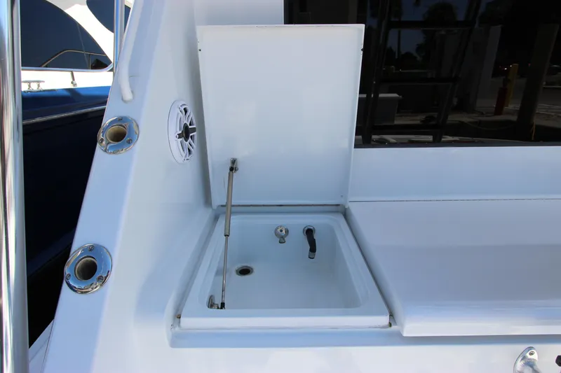 Slide: The Image of 2004 Hatteras 60 Convertible yacht sink and storage area on deck. - 17