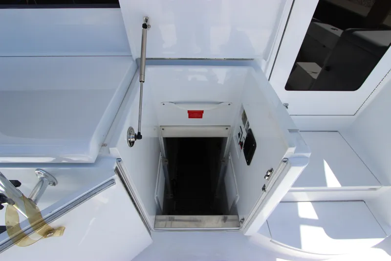 Slide: The Image of 2004 Hatteras 60 Convertible yacht interior access hatch, white finish, open door. - 22