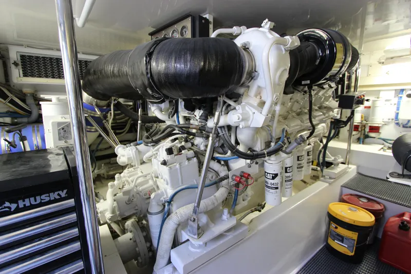 Slide: The Image of Engine room of a 2004 Hatteras 60 Convertible yacht, showcasing machinery and equipment. - 27