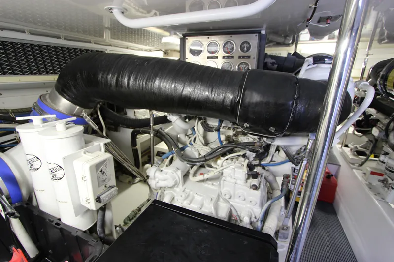 Slide: The Image of Engine room of 2004 Hatteras 60 Convertible yacht, showcasing machinery and control panels. - 28