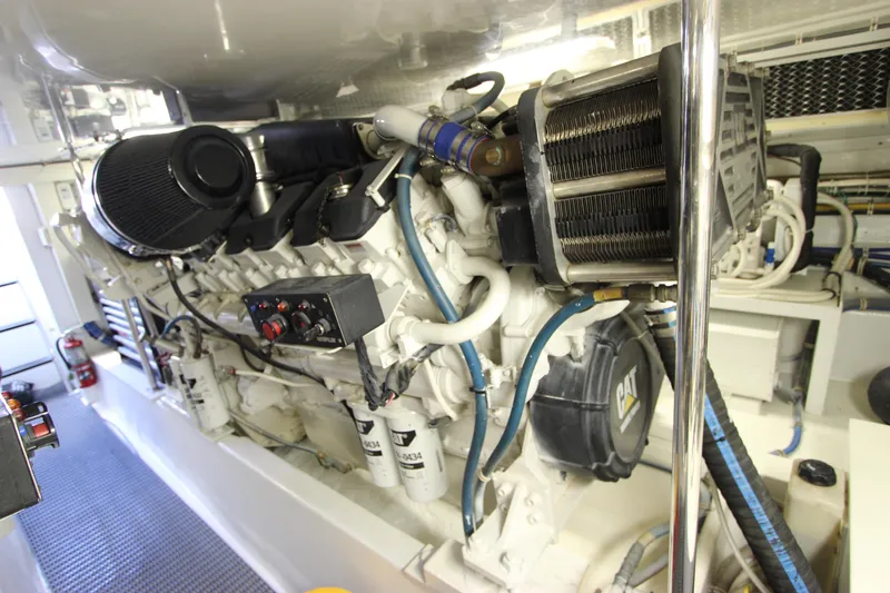 Slide: The Image of Engine room of 2004 Hatteras 60 Convertible yacht, showcasing powerful machinery and components. - 29