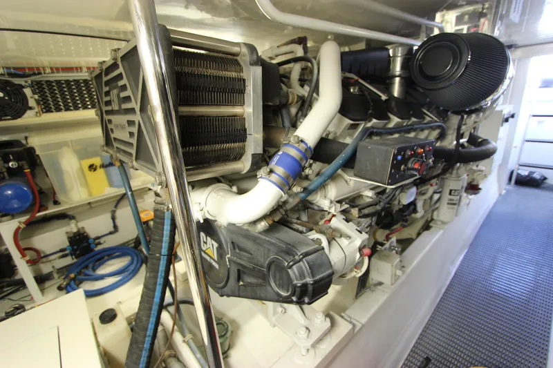 Slide: The Image of Engine room of 2004 Hatteras 60 Convertible yacht, featuring CAT machinery and components. - 32